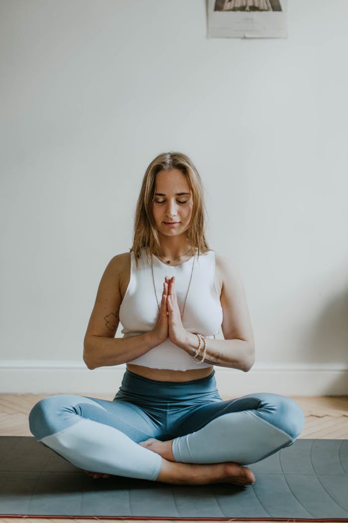 core-values A serene image of a woman practicing meditation indoors, promoting mindfulness and wellbeing.
