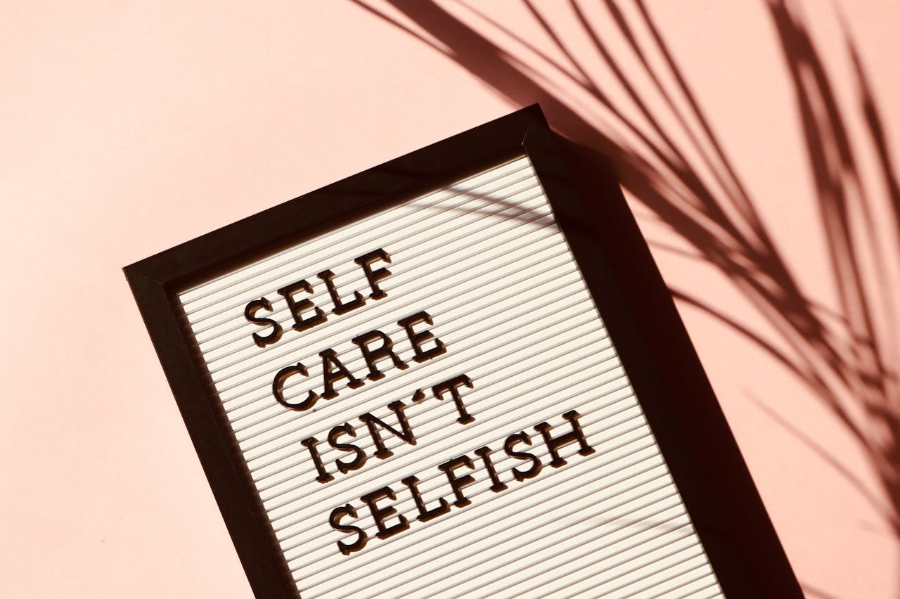 portfolio-03 Letter board displaying Self Care Isnt Selfish with artistic shadow on pink background.